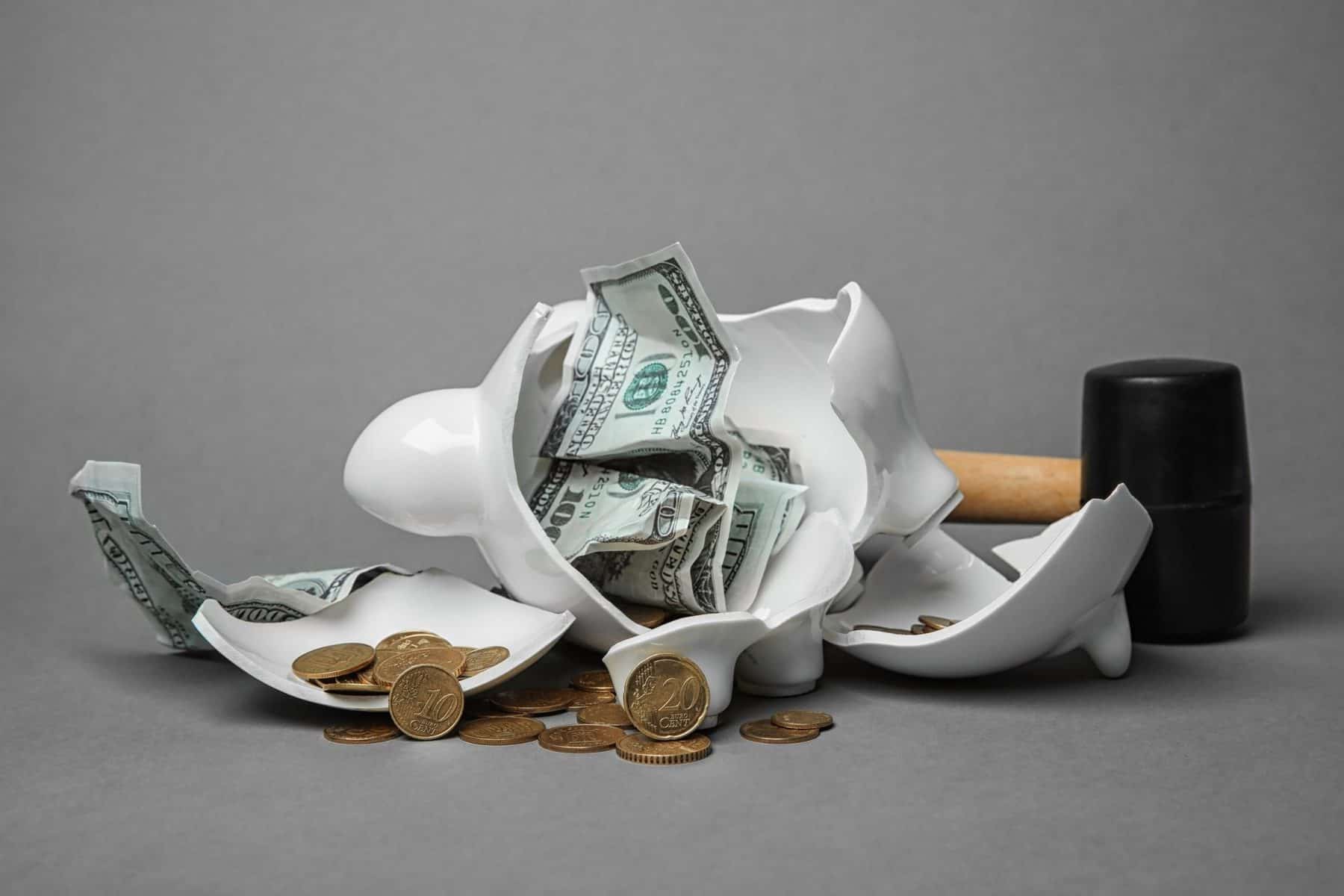 Smashed piggy bag highlighting the cost of kayaks