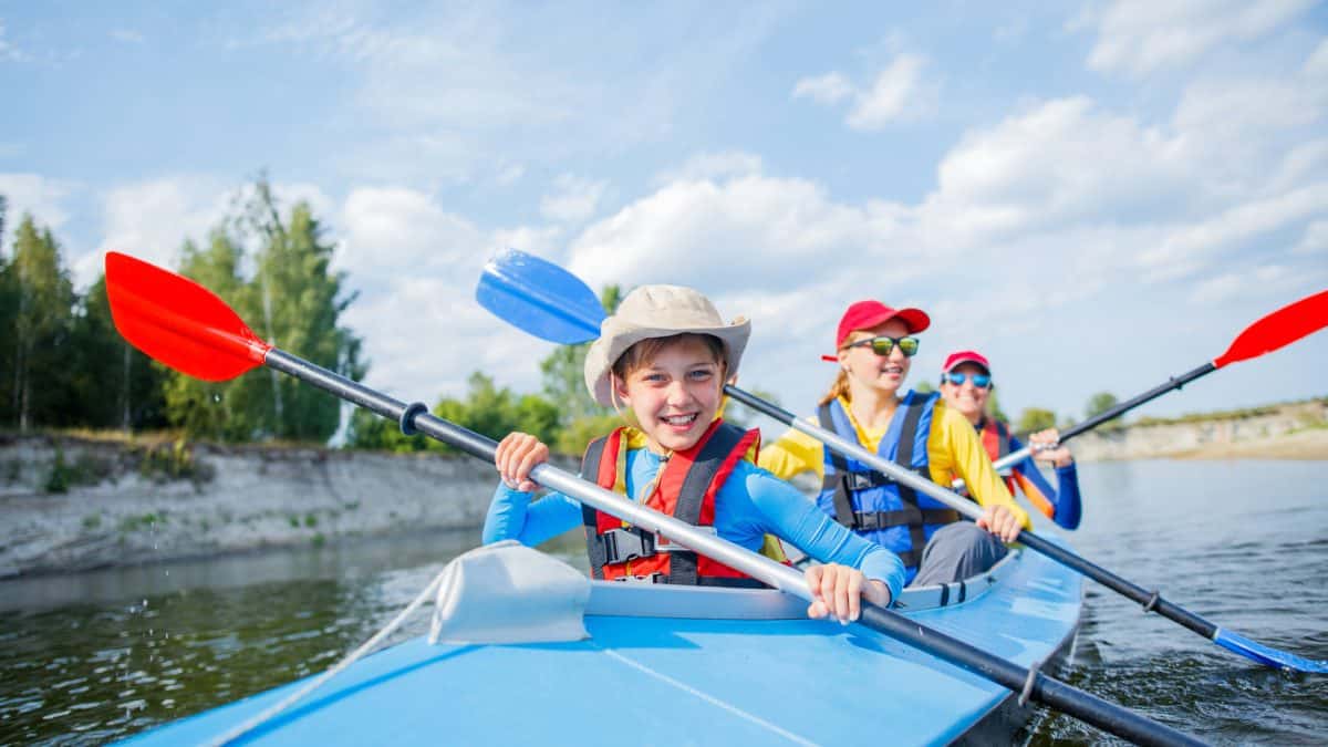 dad, mum and son in 3 person kayak