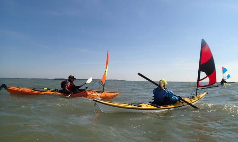 two kayaks with sail in open sea