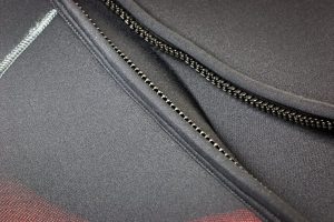 Zipper of a black neoprene diving wetsuit