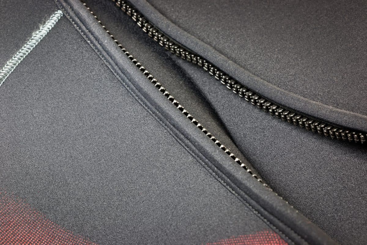 Zipper of a black neoprene diving wetsuit
