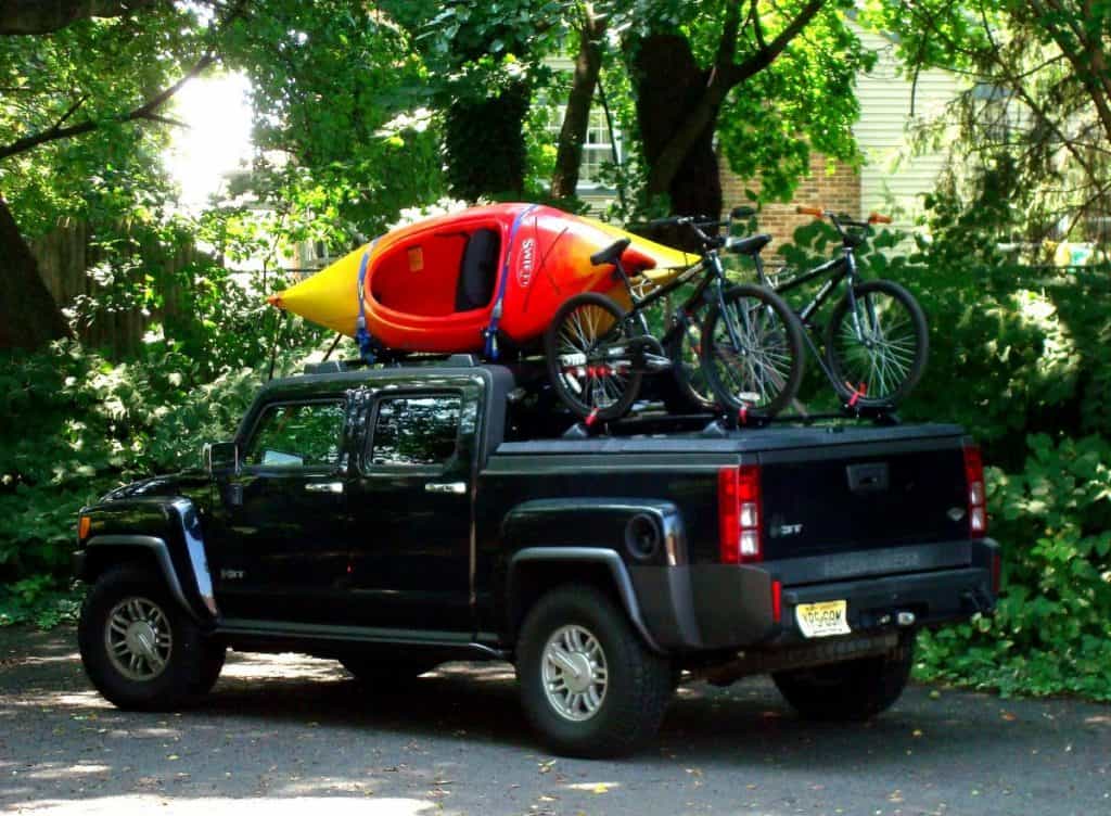 Kayaks and bikes being transported on black truck