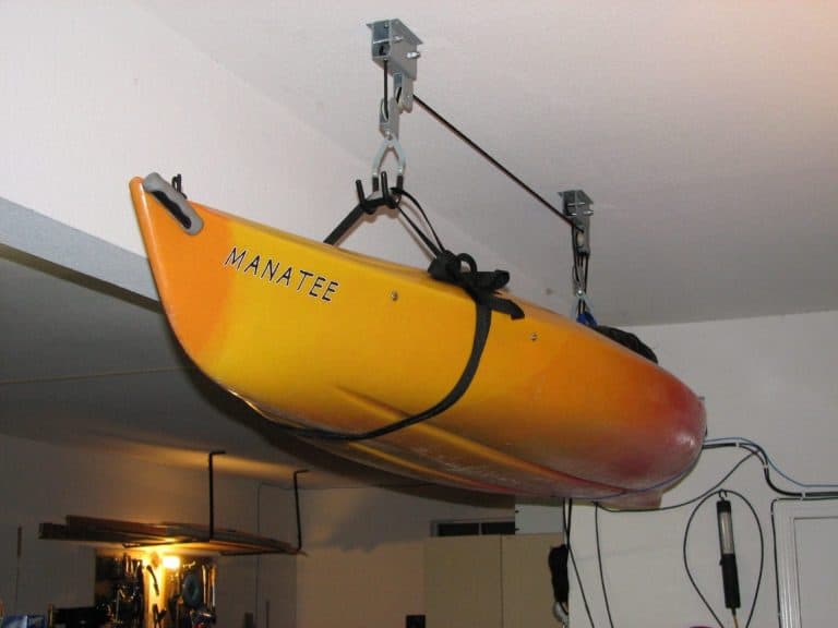 Kayak suspended in pulley hoist system