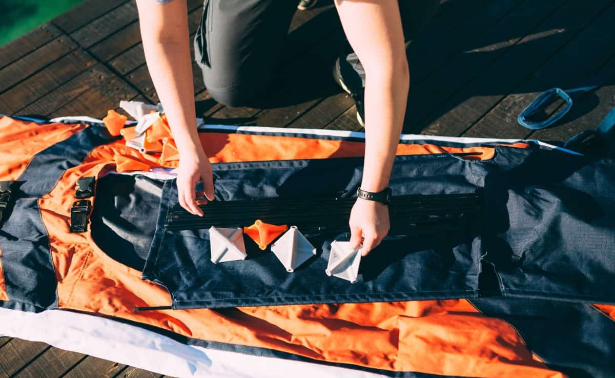 Man assembling a folding kayak on the pier
