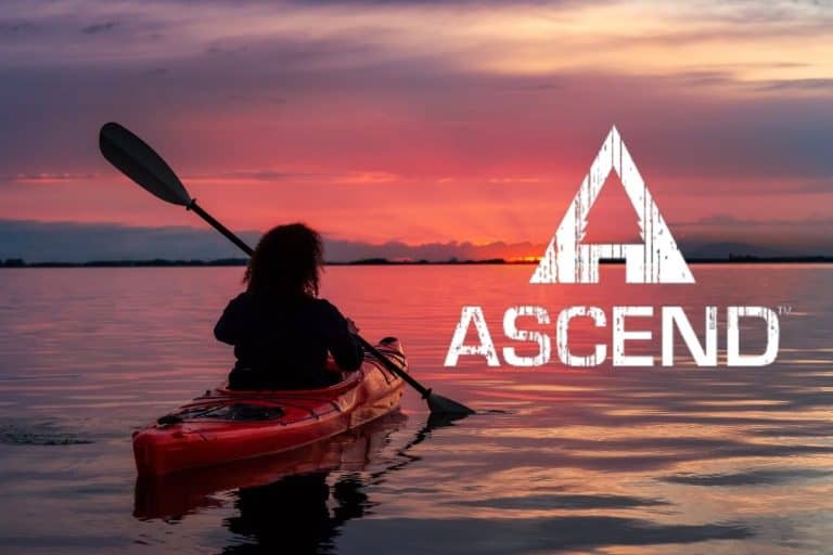 Man paddling an Ascend Kayak at sunset