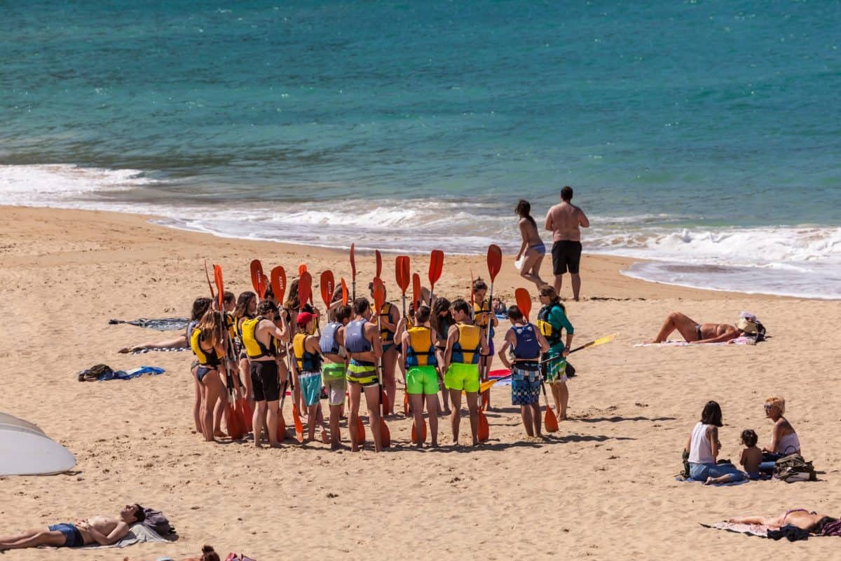 Beginner kayakers taking a lesson on the beach