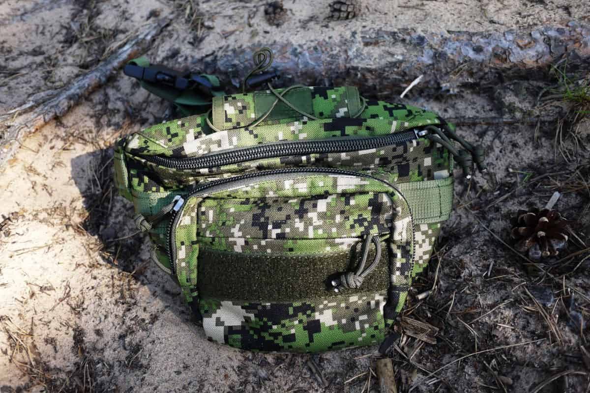 best waterproof fanny packs - camo bum bag on dirt backdrop 