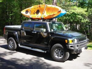Two kayaks being transported on pick up truck rack