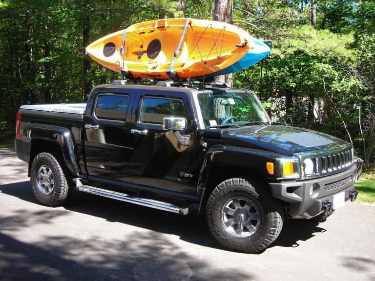 Two kayaks being transported on pick up truck rack