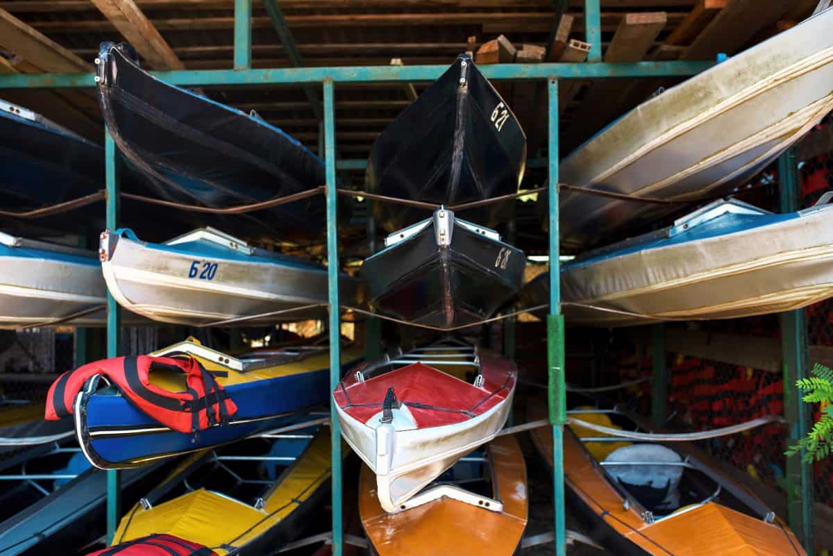 Collection of colorful kayaks on shelves