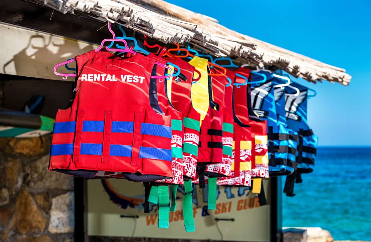 Colorful tall nylon life jacket hanging outdoor local store