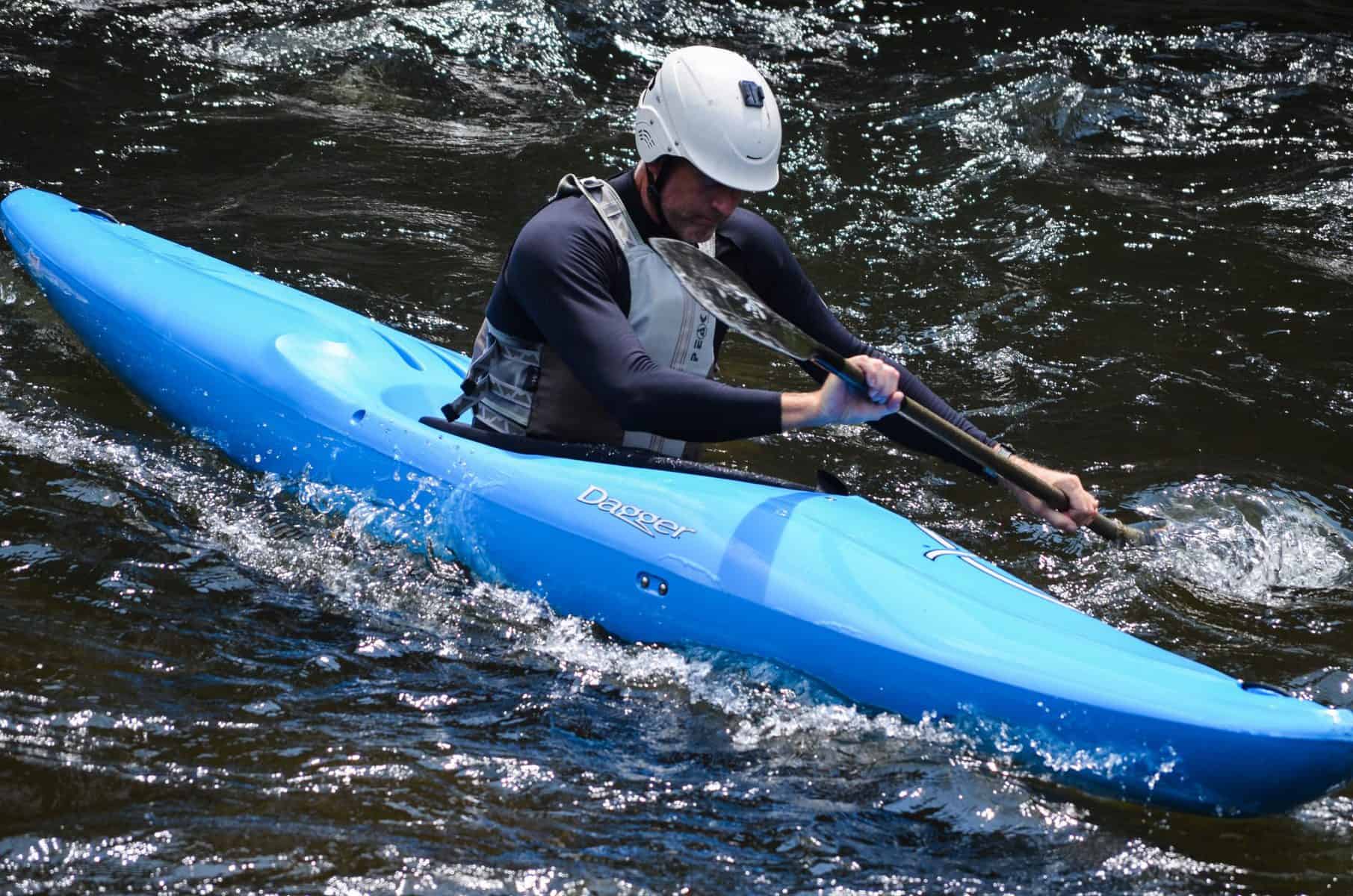 Man in blue Creeker whitewater kayak