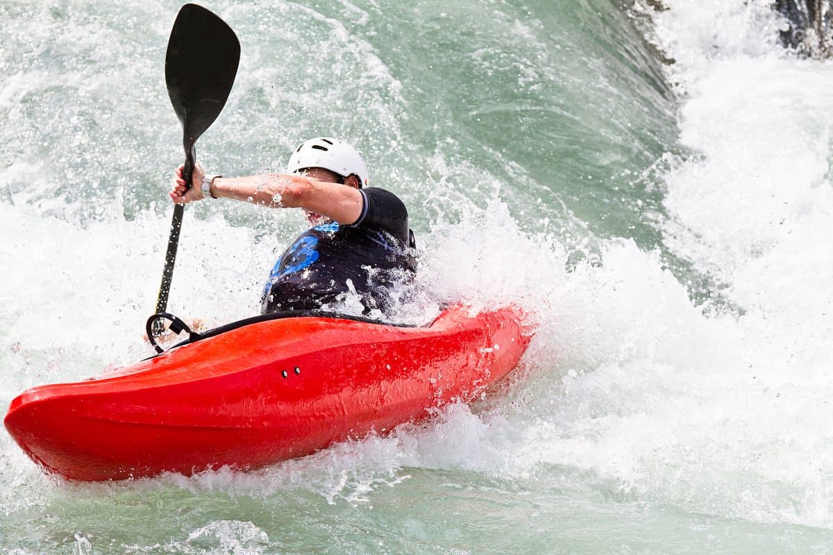 Man battles rapids in Red Whitewater kayak