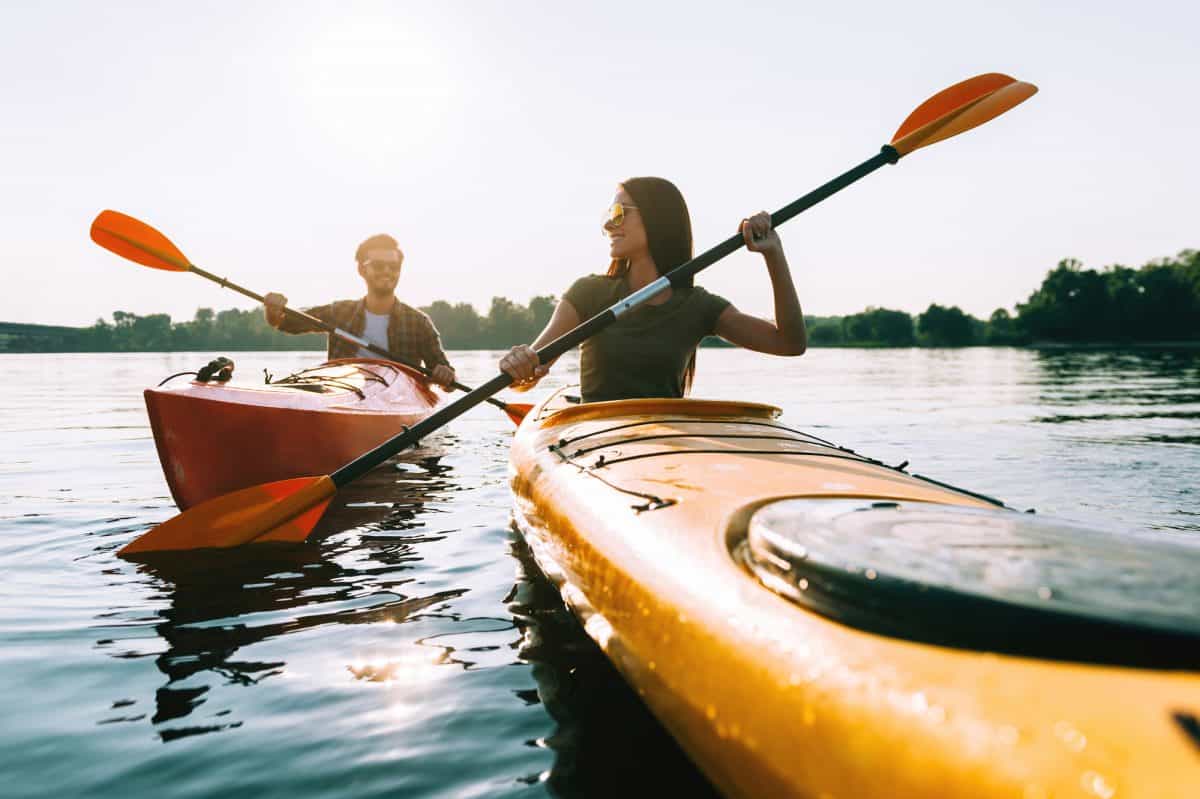 Couple in Sit-In Kayaks on a lake