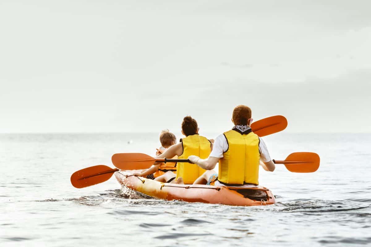 Family paddling in 3 person kayak