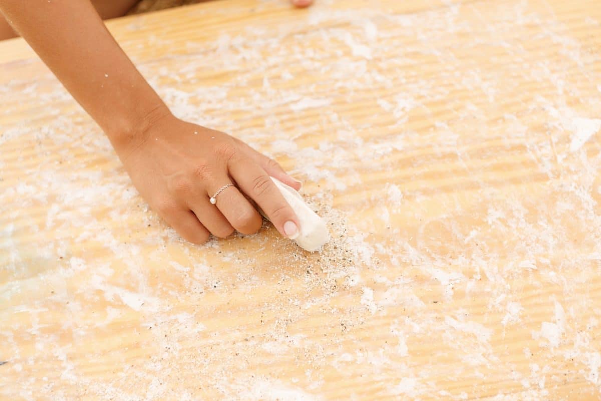 Close up view of a hand waxing a kayak