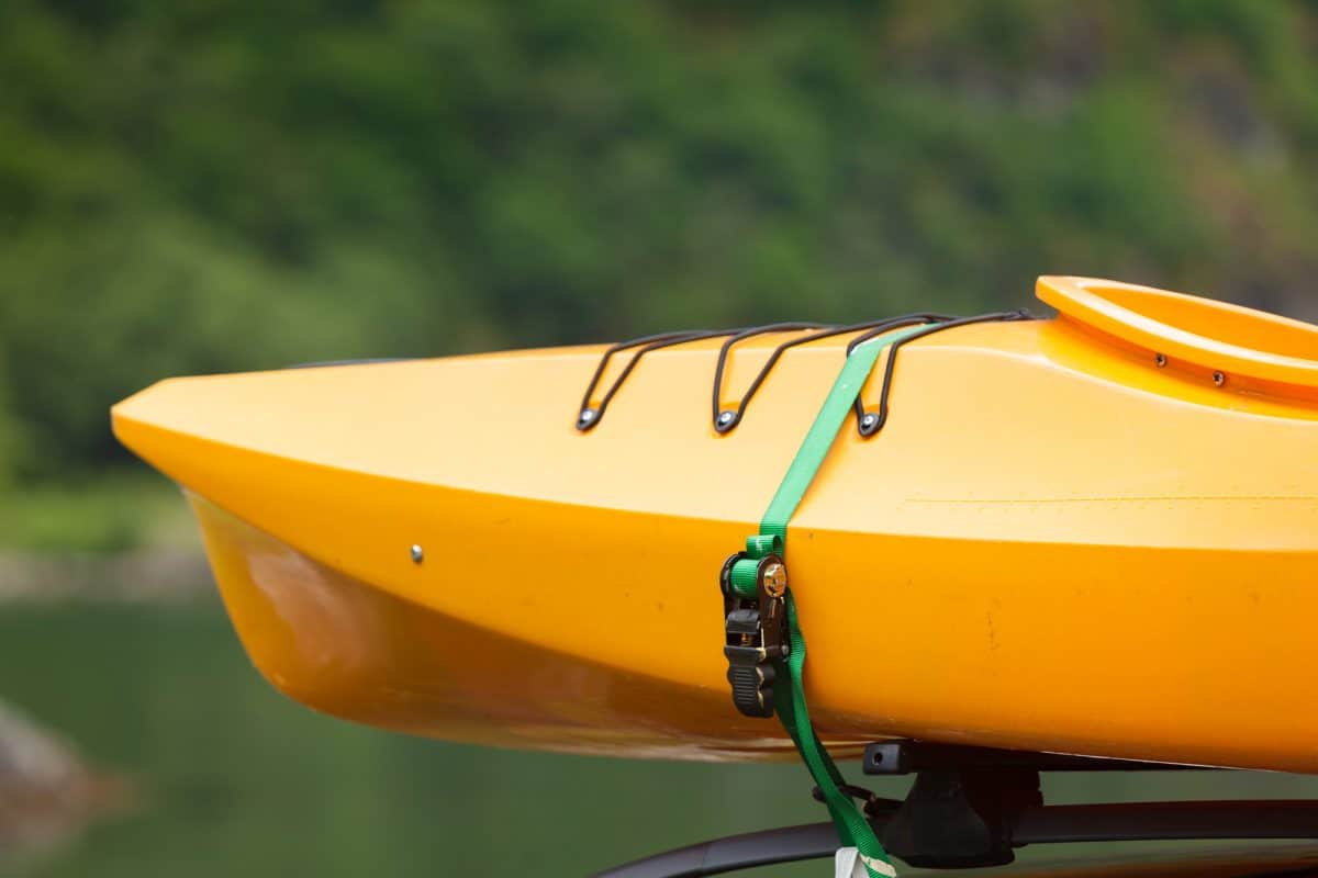 haul a kayak - kayak yellow canoe on top roof ready to transportation