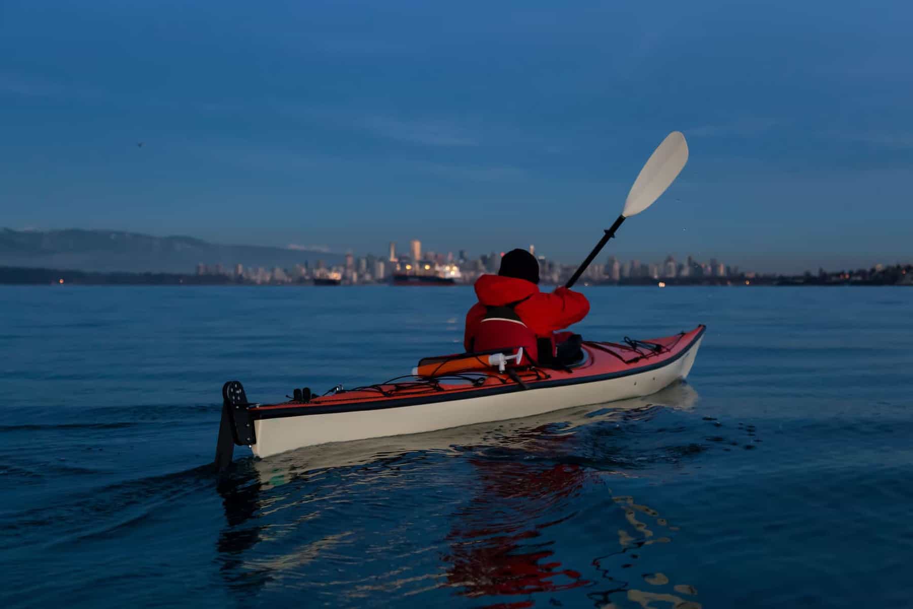 Sea Kayaker paddling with a kayak rudder in the water