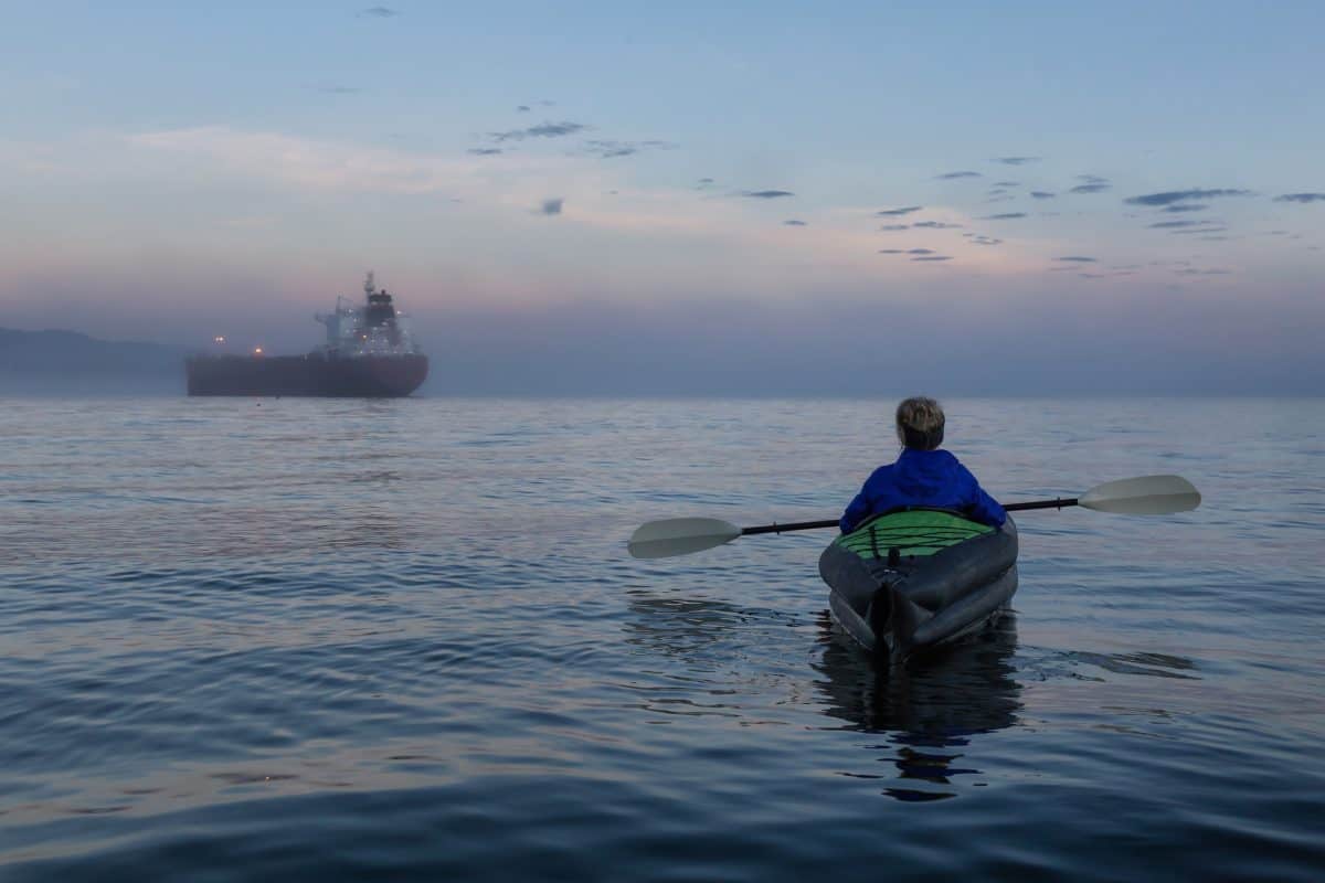 Lone girl is kayaking on an inflatable kayak