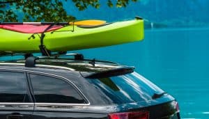 Kayak Roof Rack and the Green Kayak Mounted on the Vehicle Roof.
