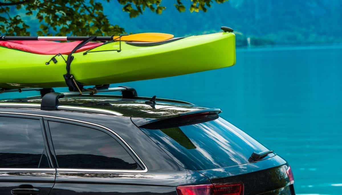 Kayak Roof Rack and the Green Kayak Mounted on the Vehicle Roof.