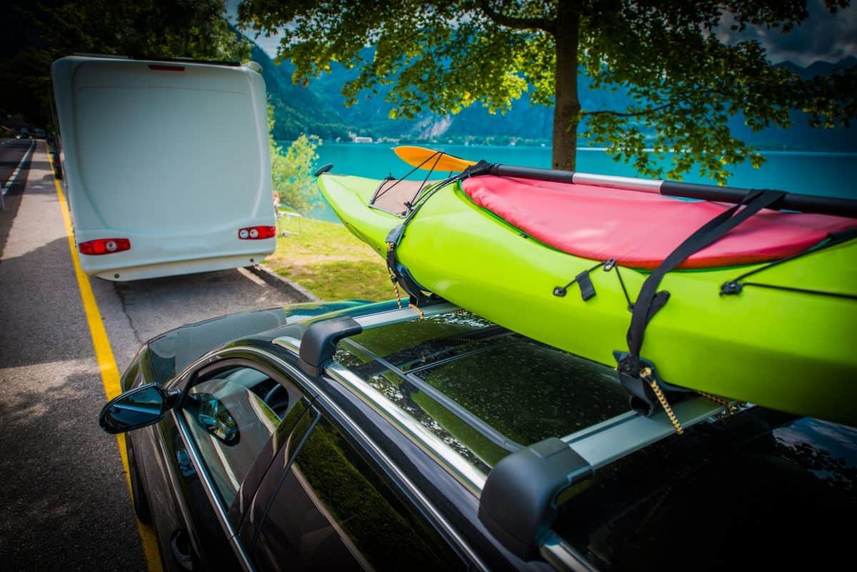 Green Kayak Transportation on the Car Roof Rack.