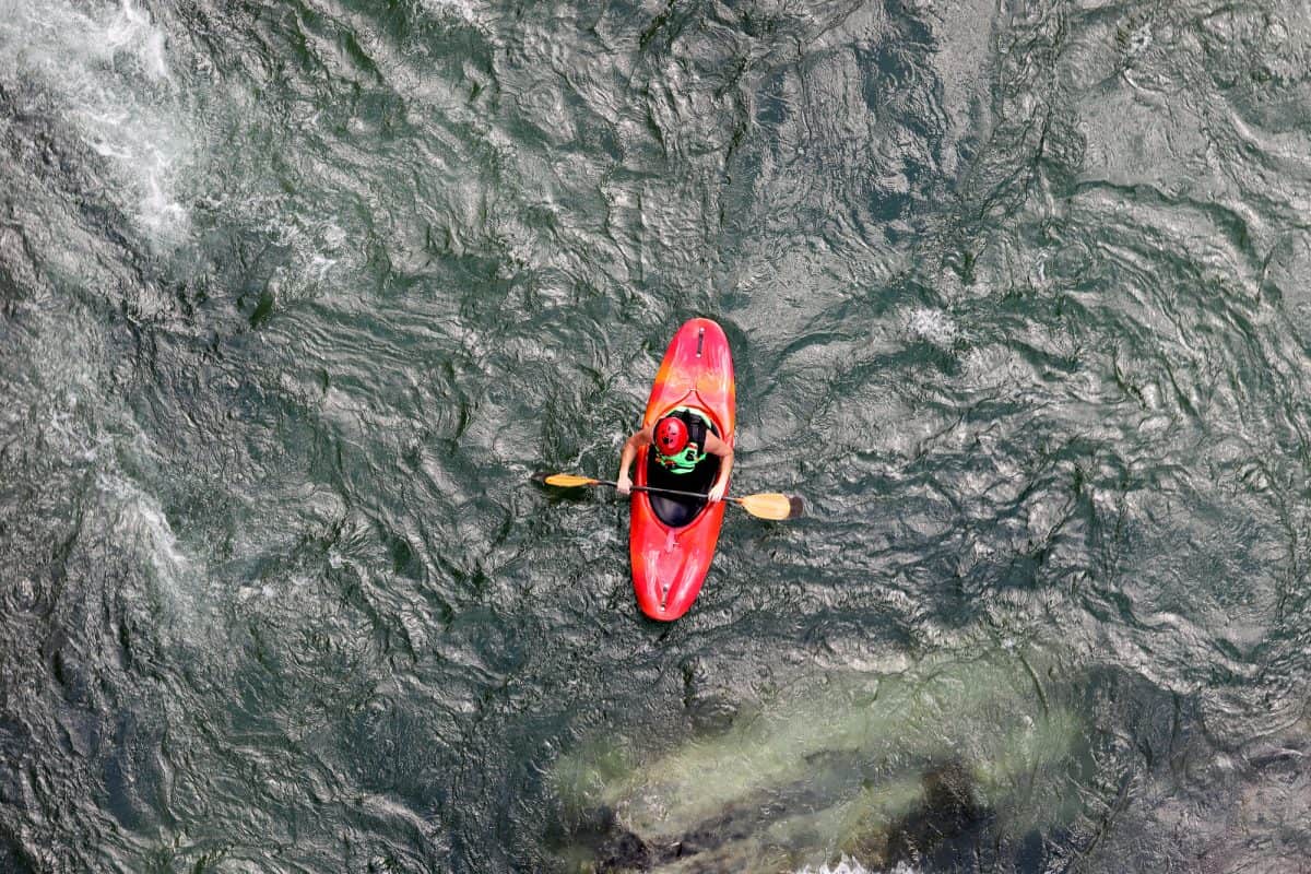 upstream and downstream kayaking in red play boat