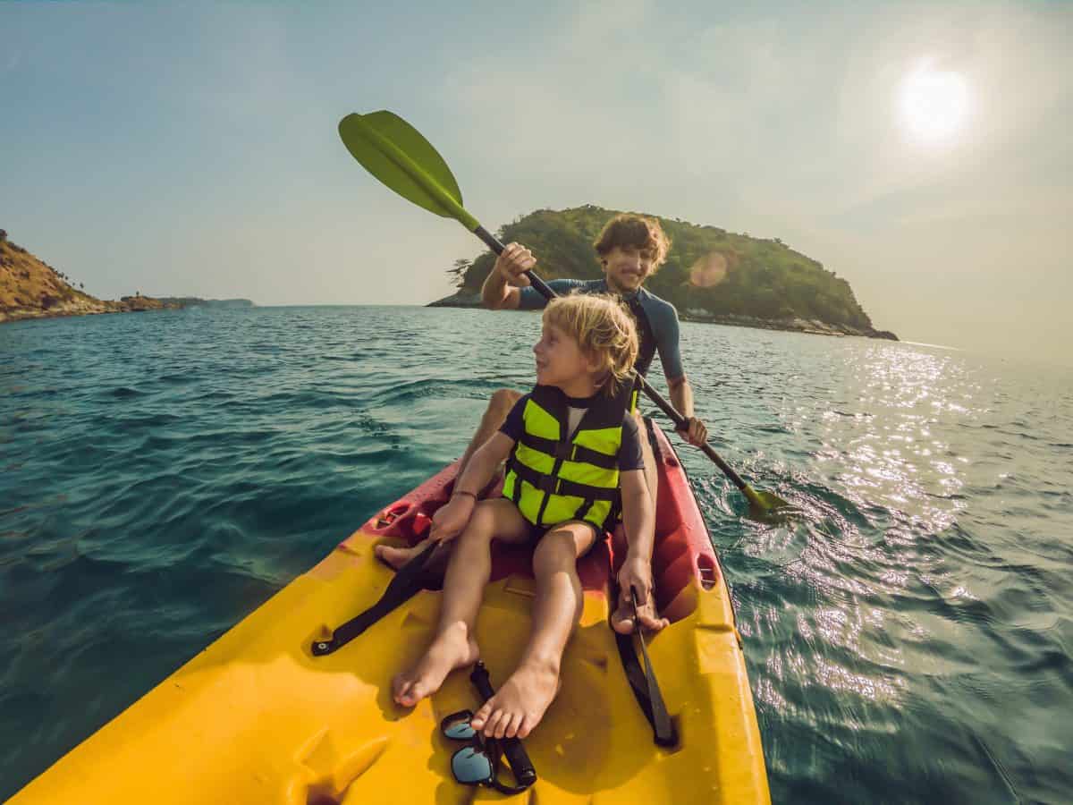 father and son kayaking as a family