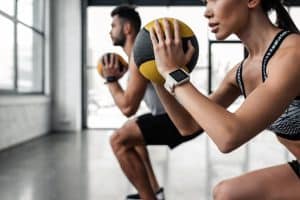 Couple training for kayaking with medicine balls