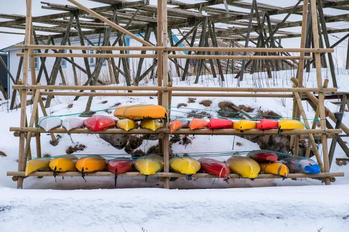 Colorful Kayak stored on wooden rack in winter season