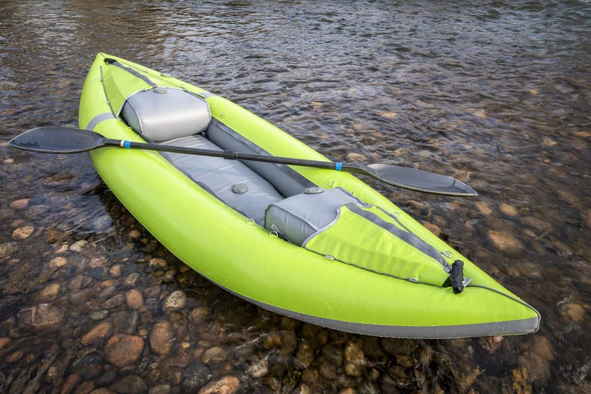 inflatable kayak on shallow rocky river