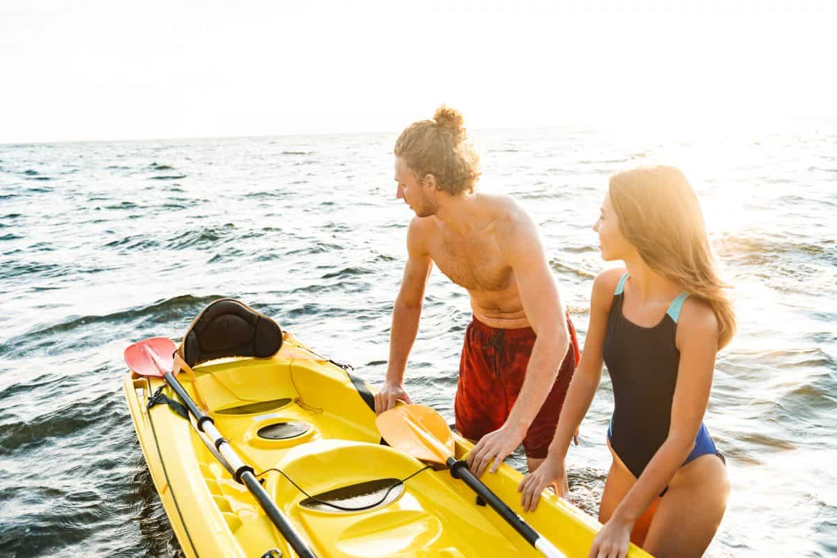 Attractive couple kayaking in the summer