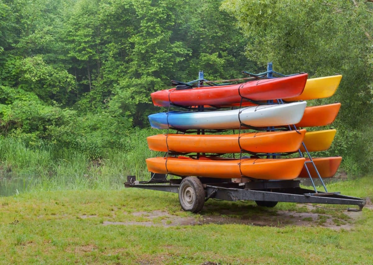 Kayaks on the trailer with eight canoes, kayaks by car delivered to the river