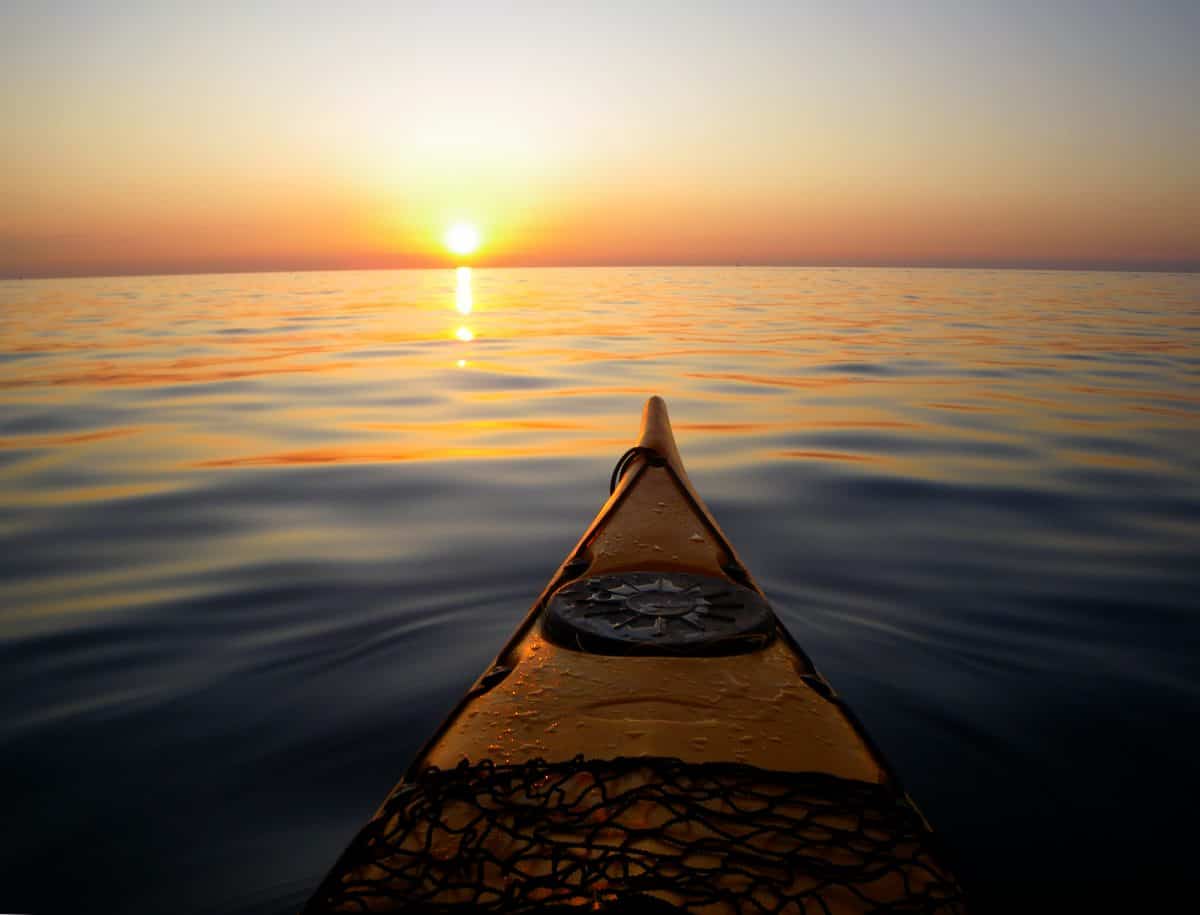 view from sea kayak at sunset