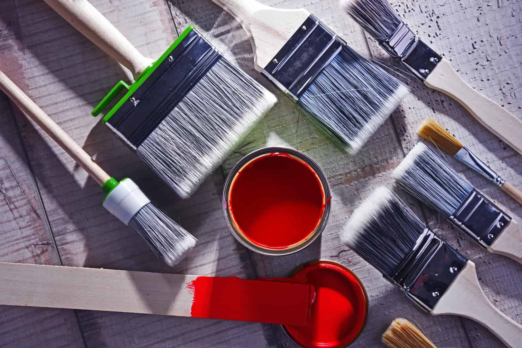 Can you paint a kayak - tin of red paint and collection of brushes 