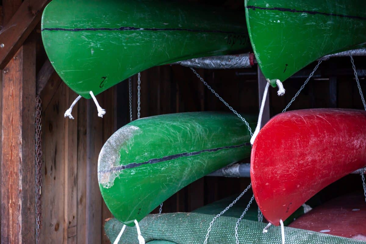 Damaged kayaks on a storage rack