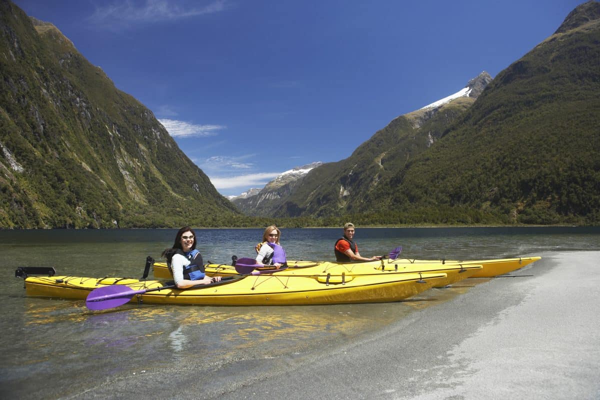 Three people each in a long touring kayak