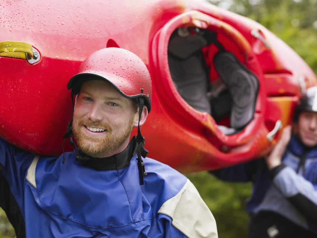 Two Kayakers Carrying Boat