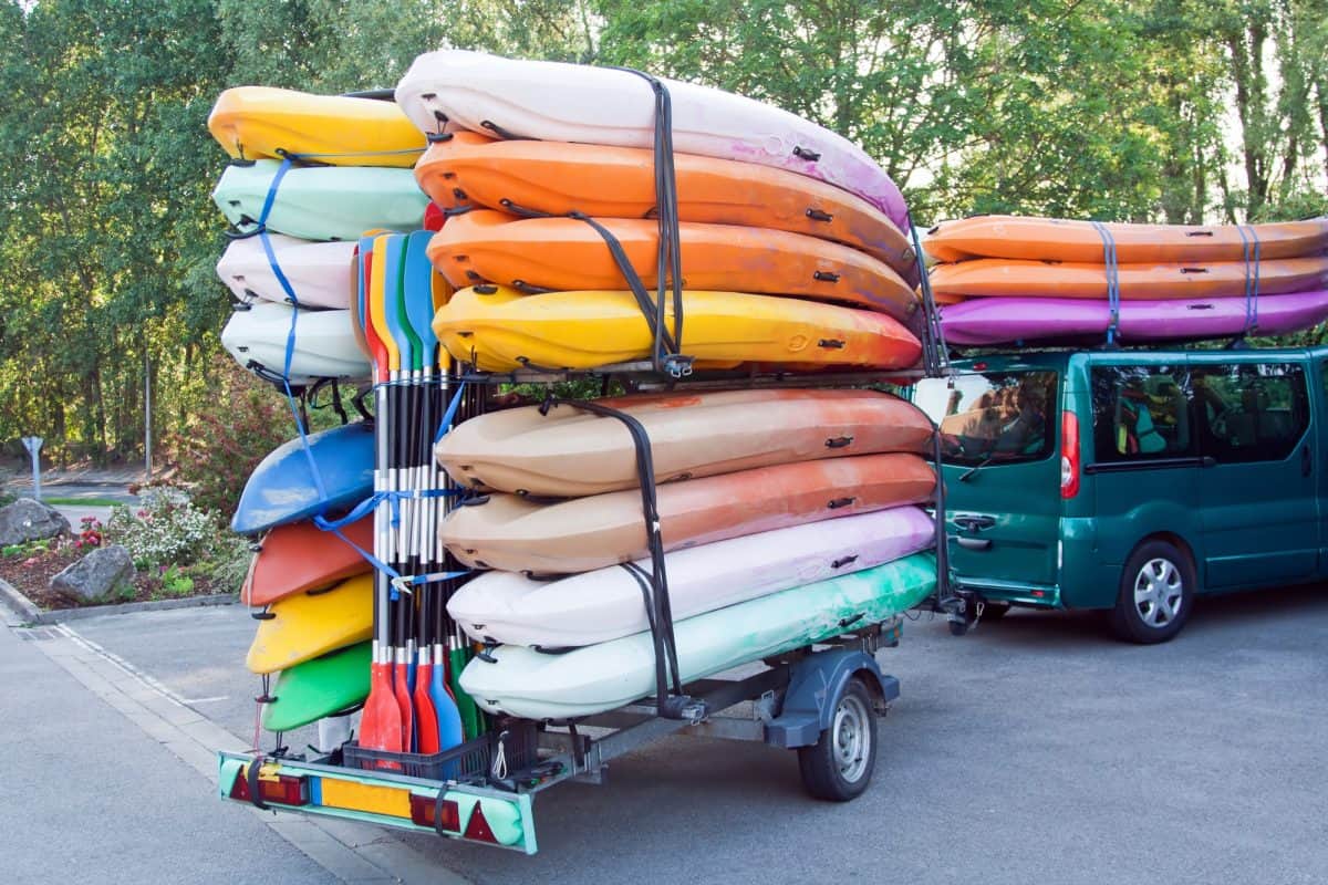 Car with trailer with kayaks and paddles