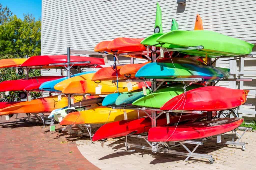 Colourful kayaks and canoes on sale outside sports shop