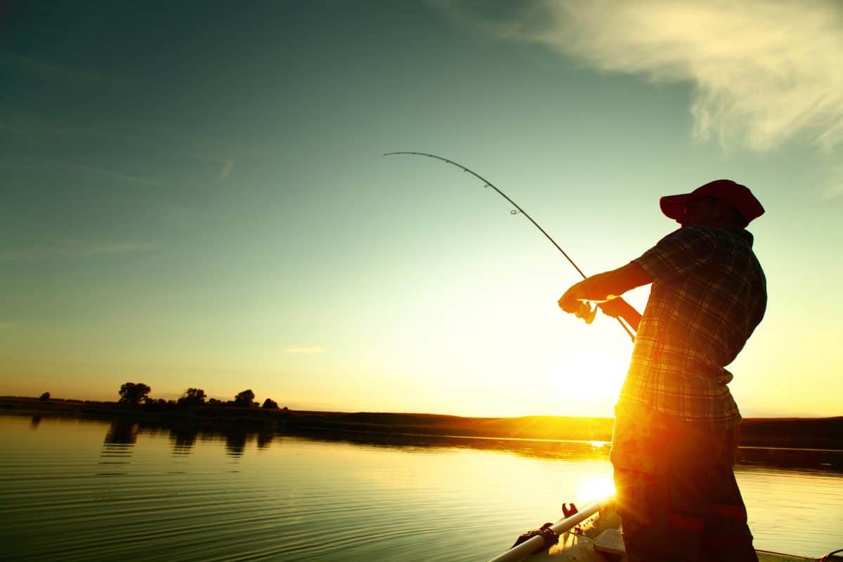 Man Fishing from a Kayak at sunset