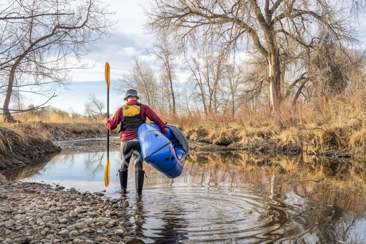 Senior male paddler is launching his inflatable kayak