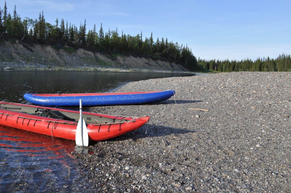 2 Inflatable kayaks on the shore taiga rivers