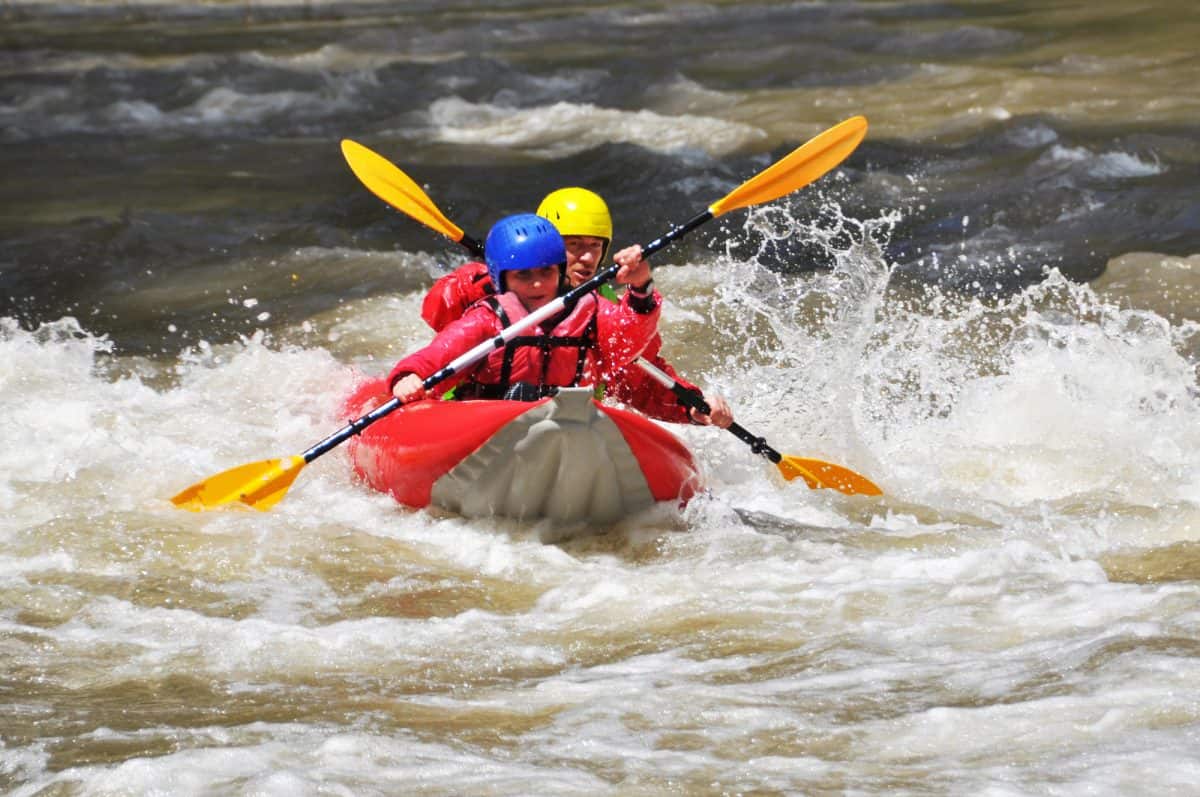 Kayak Duckie with two paddler in whitewater
