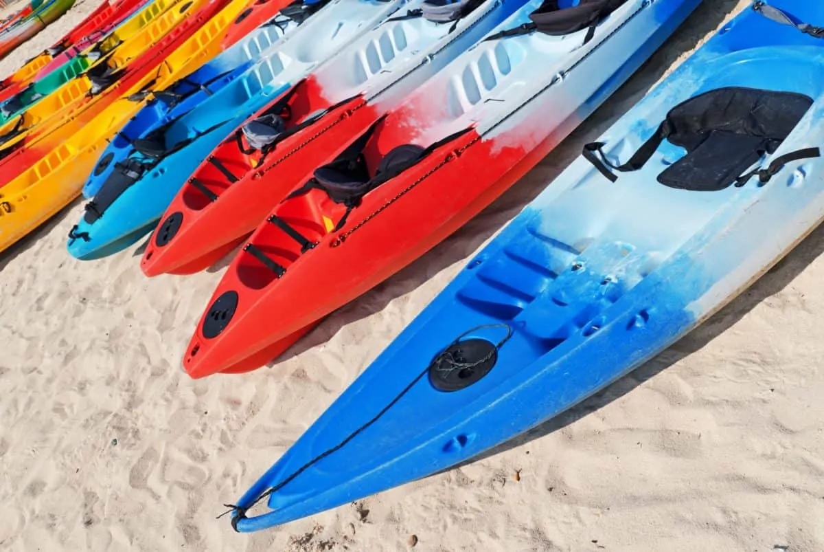 Kayaking with bad knees - Colourful kayaks on the beach.