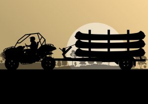 car pulling kayaks on a trailer