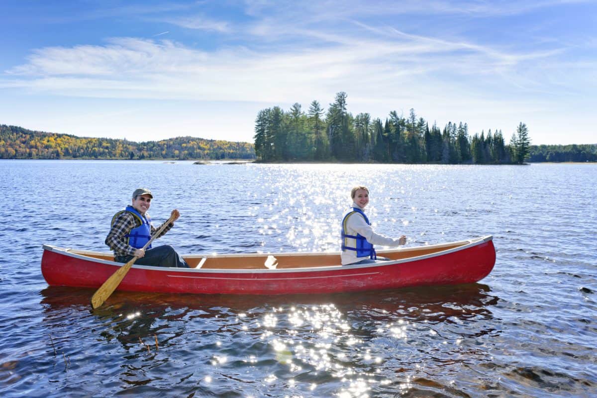 Family canoeing on sunny Lake