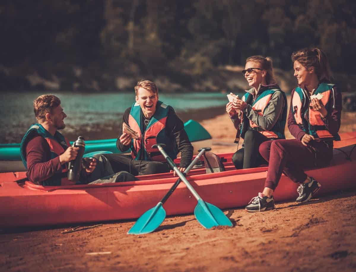 Kayakers having snack on their boat