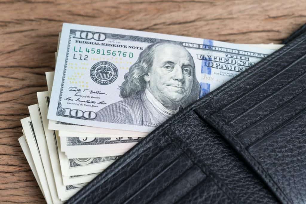 Wallet fully of money ready to buy a stand up paddle board