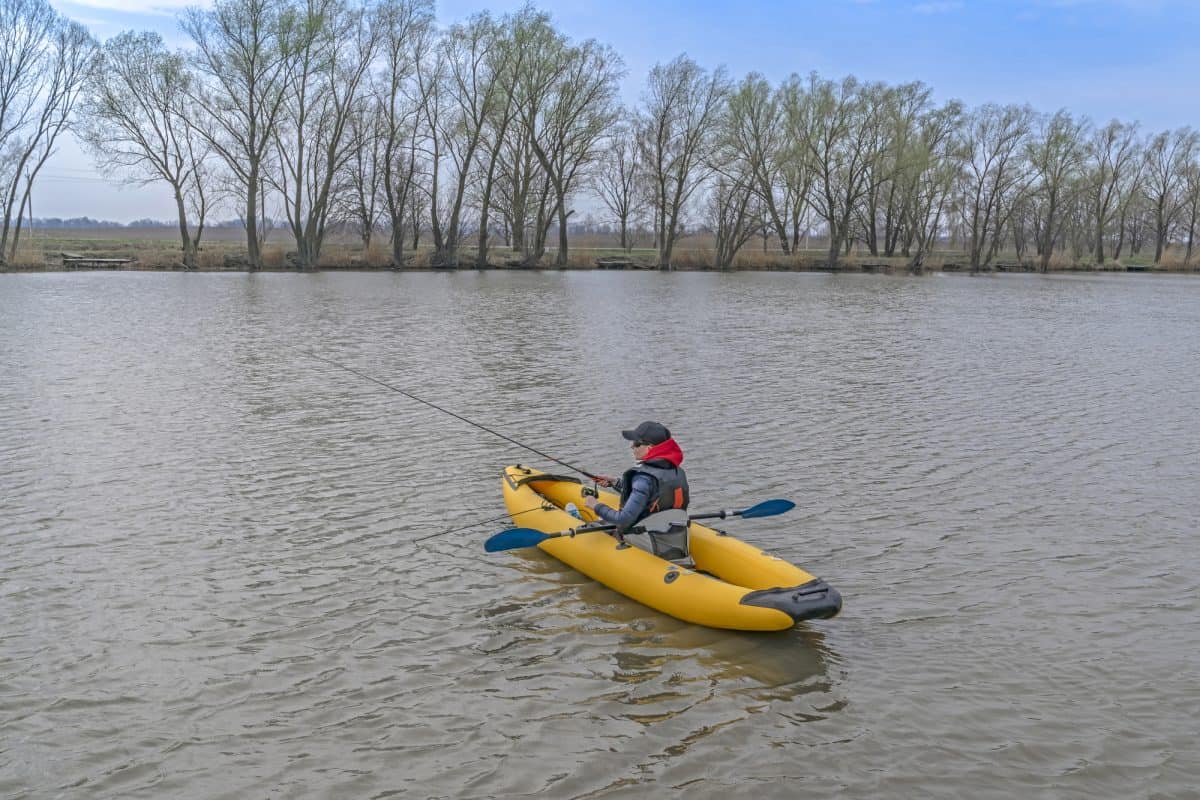 Man in inflatable fishing kayak